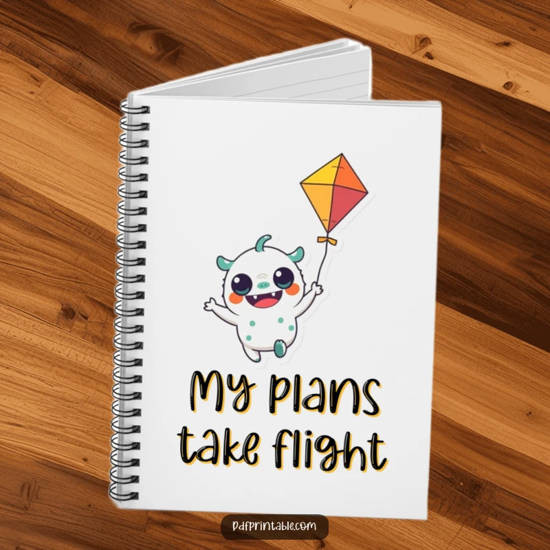 Funny Notebook: A notebook cover with a cheerful monster character holding a colorful kite flying, ideal for jotting thoughts.